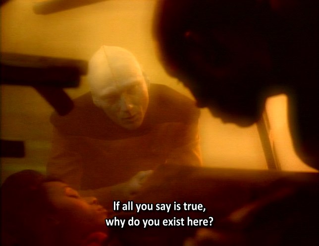 Sisko in the Wormhole, seen in a memory of him on the Saratoga, standing over Jennifer's lifeless body. A prophet is seen, in the image of a Bolian crewmember. Prophet: "If all you say is true, why do you exist here?"