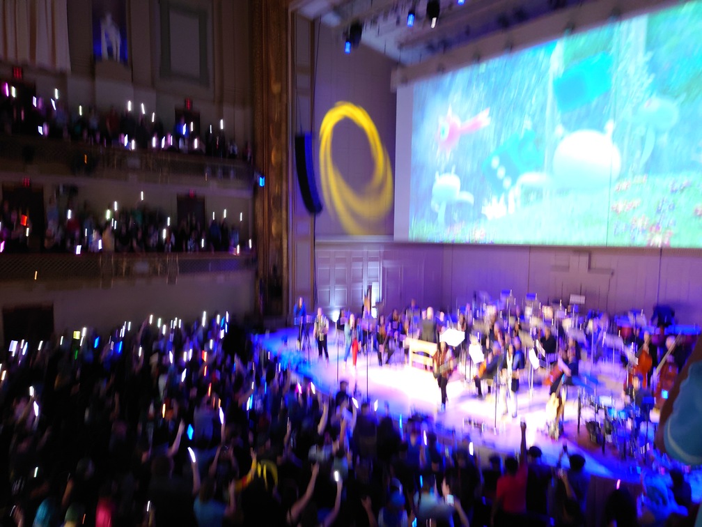 During "Reach For the Stars", the band asked everyone to turn on their flashlights. Really blurry picture this time, but you can see a bunch of phone lights and glow sticks all throughout the audience.