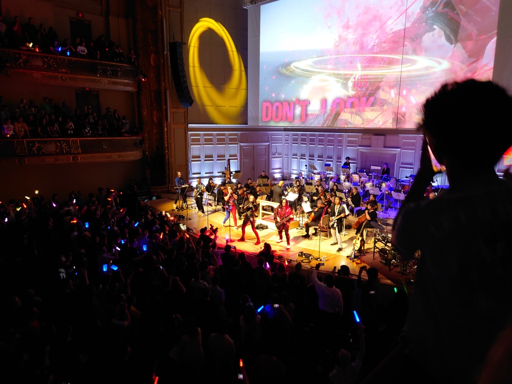 The band performing "Break Through it All" while looking really, really cool. Also some Sonic Frontiers stuff on the screen, naturally.