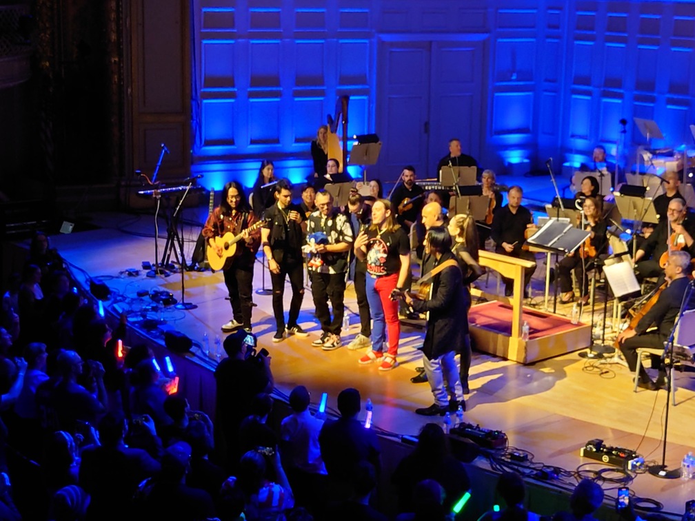 The bandleaders in a little ring at the front of the stage, performing an incredible acoustic rendition of "One Way Dream".